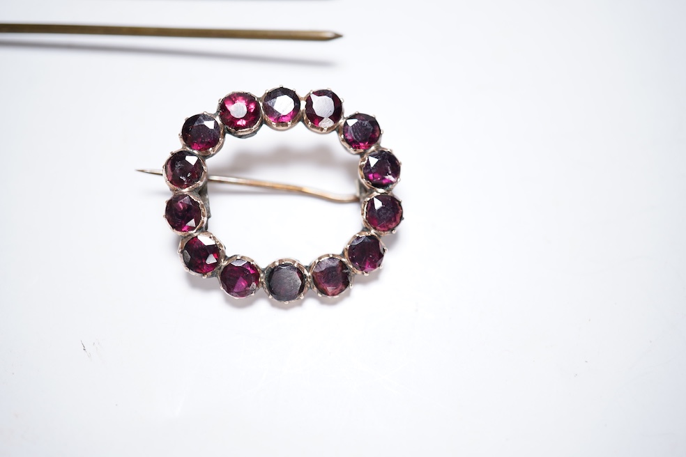 A Victorian yellow metal and garnet cluster set open work brooch, 27mm, together with two garnet cluster set hair ornaments. Condition - poor to fair